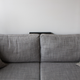 Silly as it seems, I like to stuff the secondary speaker between the cushions and the wall, since I don’t have space to put a table back there.
